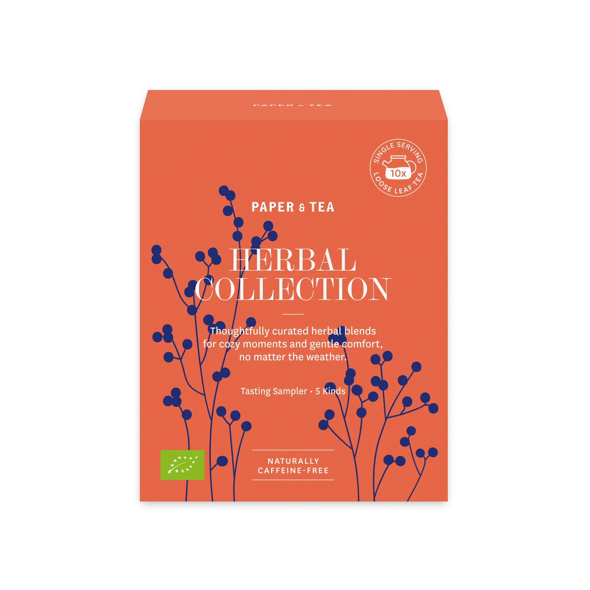 Orangefarbene rechteckige Box mit Paper & Tea Kräutersortiment, blauen botanischen Illustrationen und Bio-Siegel, enthält 10 Einzelportionen losen Tee.